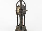 an old metal clock with a bird on top of it