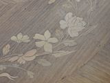 a close up of a wooden table with flowers on it