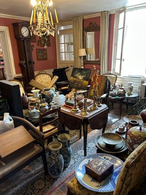 a living room filled with lots of furniture and a chandelier