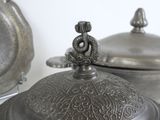 a close up of a silver plate with a dragon on it