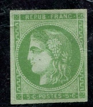 a green stamp with a woman ' s face on it