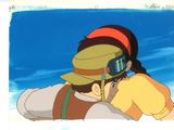 an image of a man and a woman hugging each other on a beach