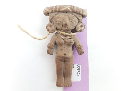 a small clay figurine of a woman with a hat on
