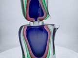 a glass vase with a blue and green design on it