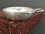 a silver bowl sitting on top of a red box