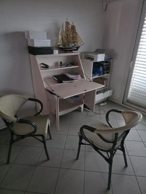 two chairs and a desk in the corner of a room