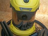 a yellow and black vacuum on the floor next to a black hose