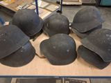 six helmets are on a cart in a warehouse with other items