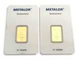 two gold bars are shown side by side on a white surface