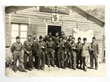 a group of men in uniform standing outside of a building