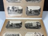 an old black and white photo of an open book with pictures of buildings