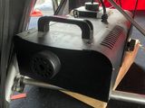 a black smoke machine that is sitting on the floor