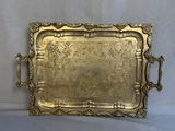 an ornate brass tray with handles and handles on a white background
