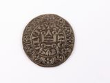an old coin on a white surface with a white background