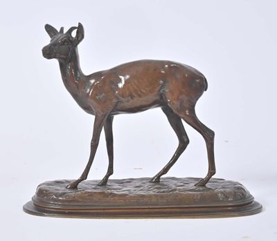 bronze statue of a deer on a wooden base on a white background