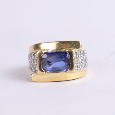 an image of a ring with a blue sapphire and diamonds