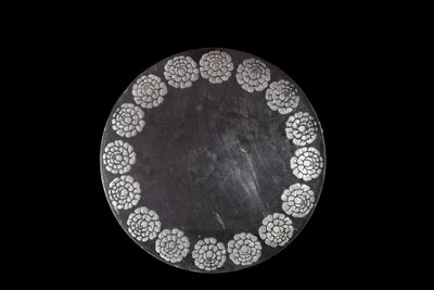 a black and white plate with a circular design on it