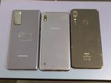 three samsung galaxy phones are sitting on a table next to each other