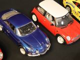 several toy cars are lined up in a row on a black surface