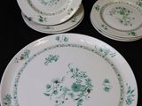 three plates and a bowl sitting on a black table