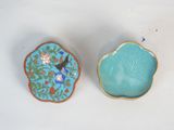 a small blue bowl and a small blue bowl on a table