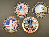 four badges of different police officers on a black surface