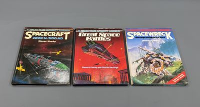 three books on a table with a space craft book in front of them