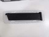 a plastic container with a magazine inside of it on a table