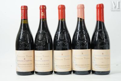 six bottles of wine are lined up on a white surface