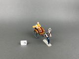 a miniature figurine of a man in a horse drawn carriage