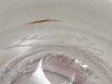 a close up of a glass with a liquid inside of it