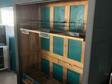 a bird cage that is in the middle of a kitchen
