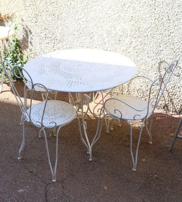 a white table and chairs outside on a patio