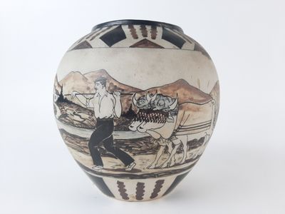 a black and white vase with a picture of a man riding a horse