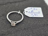 a ring with a diamond on it and a tag with a price tag