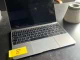 a laptop computer sitting on a desk with a cup of coffee