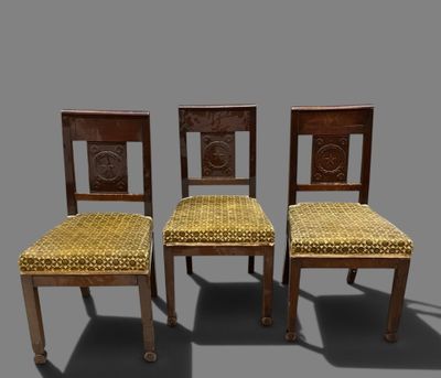three wooden chairs with yellow upholstered seats on a gray background