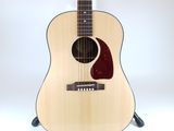 a close up of a guitar on a stand against a white background