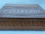an old wooden box with a carved inscription on it