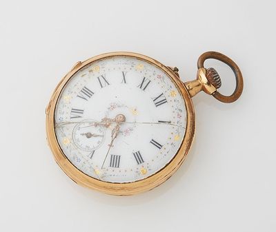 a gold pocket watch with roman numerals on it