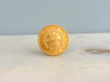 an image of a gold coin sitting on top of a marble counter