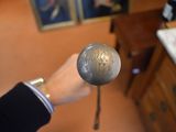 a person that is holding a silver object in their hand