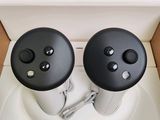 two black and white controllers on top of a white toilet
