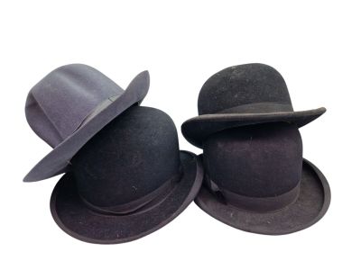 two hats sitting next to each other on a white surface