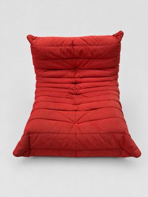 a red futon chair on a white background