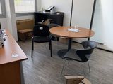 a room with a table, chairs, and a computer on it