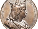 une image représentant une médaille d'argent sur laquelle figure un homme coiffé d'une couronne
