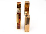 two lighters sitting next to each other on a white surface