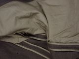 a close up of a bed with a blanket and a pillow