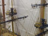 a model of a ship on display in a glass case